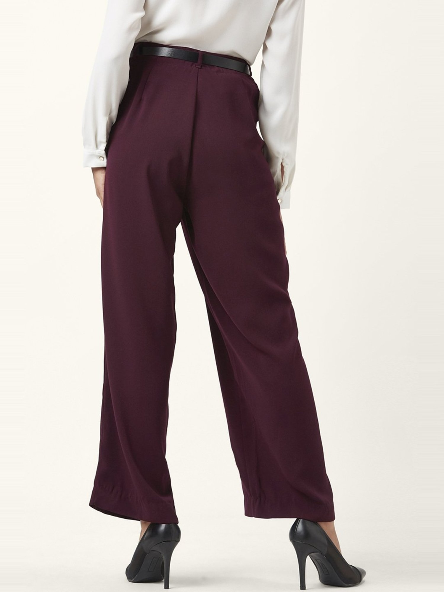 Beige belted tapered peg trousers on Stylevore