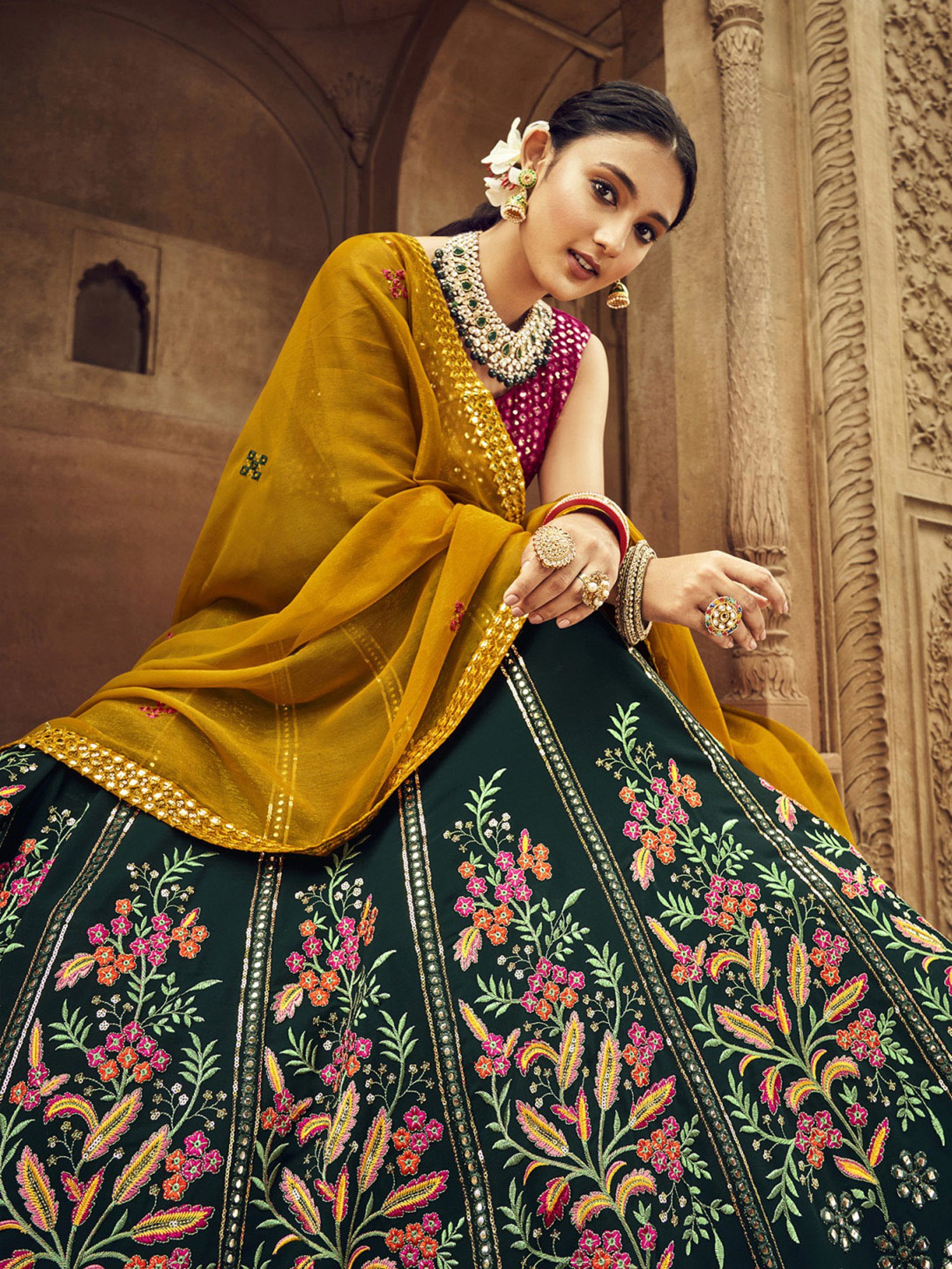 Photo of velvet forest green lehenga with salmon colored dupatta