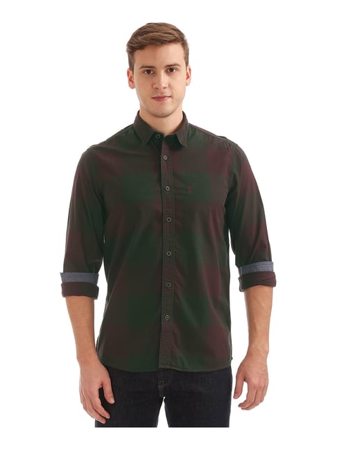 dark green shirt and blue jeans