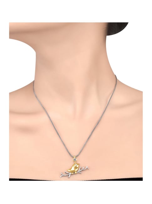 Premium Photo | A gold necklace with a small bird on it