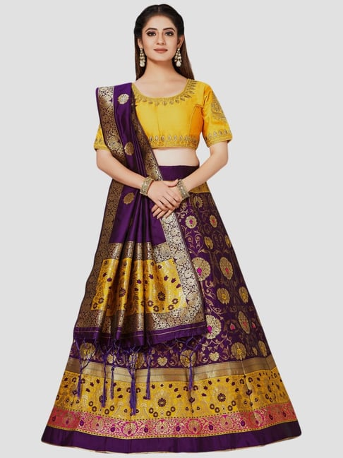 bride-groom-puja-ceremony-yellow-bandhgala-purple-lehenga-smiling-couple-the-bride-and-groom-don-contrasting-hues-and-look-like-a-million-bucks  - Witty Vows