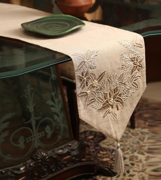 Buy Amoliconcepts Beige Table Runner with Zari Embroidery, Pearl Details and Tassels Original Home Table Linen only at Tata CLiQ Luxury