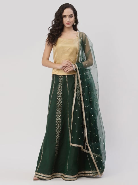 Photo of Embellished gold lehenga with contrasting green jewellery