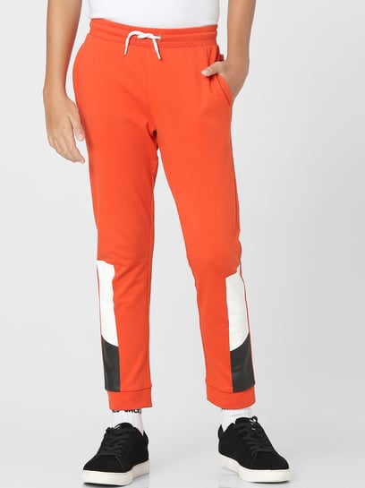 White and store orange track pants