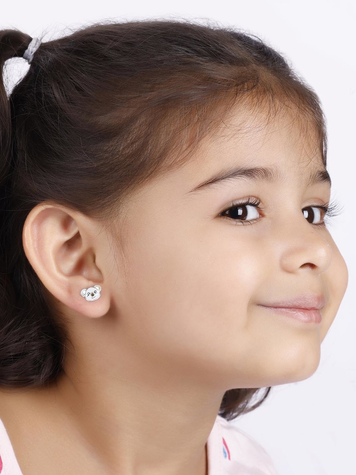 Happy infant child girl dressed in white laughing wearing headband and  earrings Stock Photo - Alamy