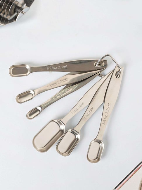 Premium Photo  Set of small metal teaspoons on a brown wooden table